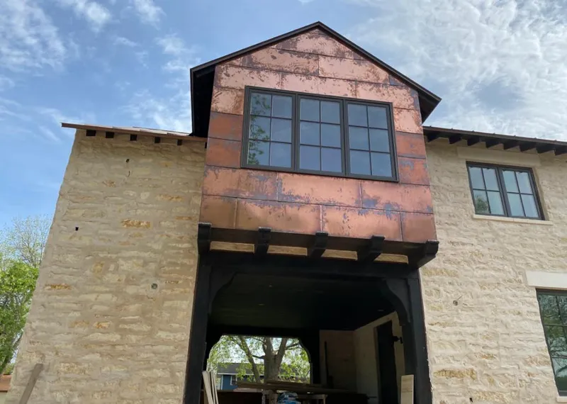 Copper metal panel facade on a stone building for Skylight Installation in Ocoee