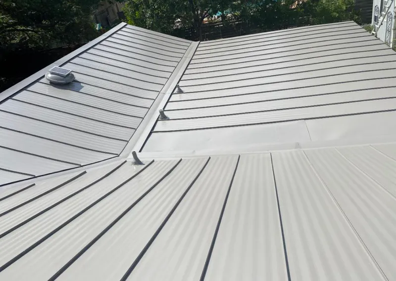 Solar attic fan installed on a metal roof for Roof Ventilation in Ocoee